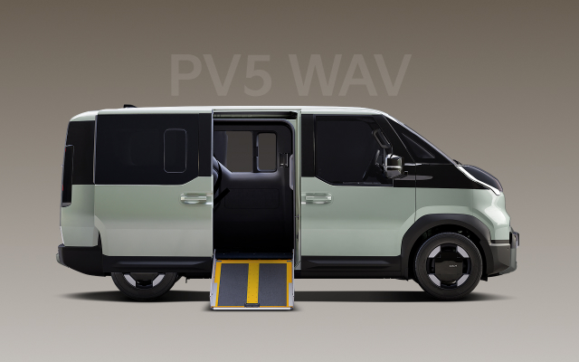 Side view of the two-tone Kia PV5 WAV with accessibility ramp extended