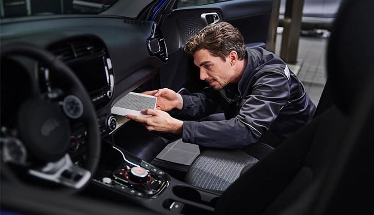 Expert Kia EV technician servicing a Kia electric car 