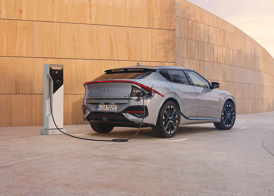 A Kia Electric car charging on the road with an Ionity Power ultra-fast electric car charger